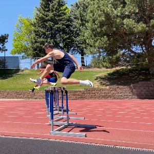 Boys jumping hurdles